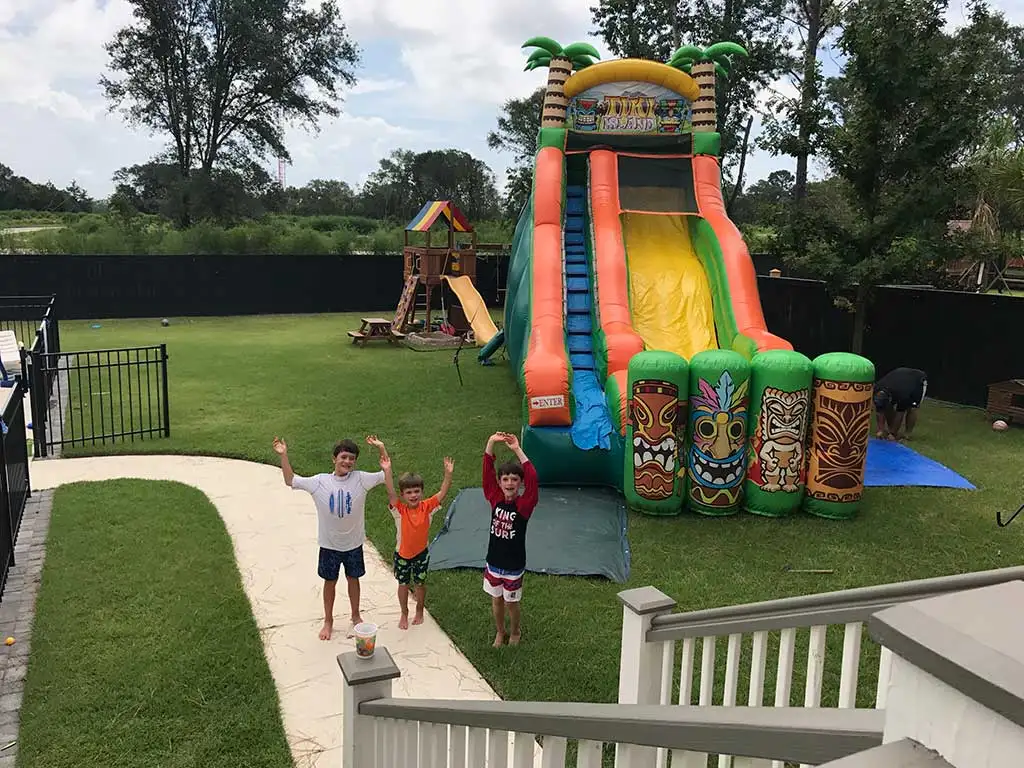 Bounce House Rentals in Jacksonville, AR: Kids having fun on a colorful inflatable.